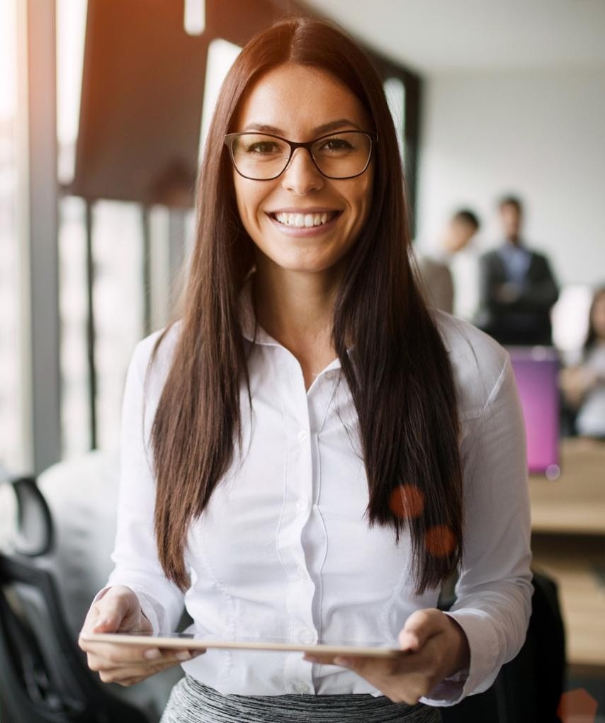 Portrait of beautiful young businesswoman holding tablet in office